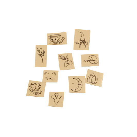 Set of small wooden stamps with various designs on a white background
